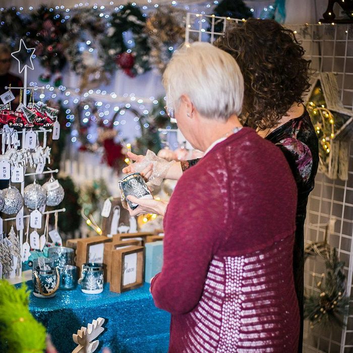 To women browsing Christmas decor in gift shop