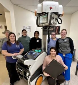 Hospital staff surrounding mobile imaging machine